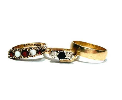 A sapphire and diamond ring on 9ct gold shanks; a garnet and opal ring on 9ct gold shank; and a 9ct gold wedding band, 7.2g g