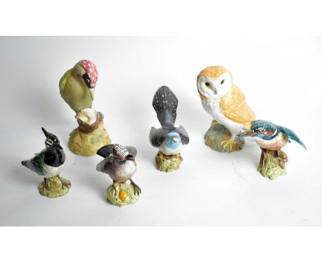 A collection of Beswick ceramic bird figures, including: an owl, 1046; a woodpecker, 1218; a Jay, 2417; and others. (6) 