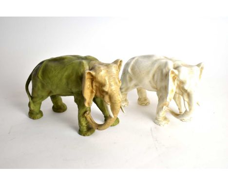 A Continental ceramic elephant figure, in the manner of Royal Dux, in green and gilt, 18cms high; together with a similar fig
