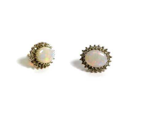 A pair of opal and diamond cluster earrings, the oval opal cabochon surrounded by 8-cut diamonds in 9ct white gold mount post