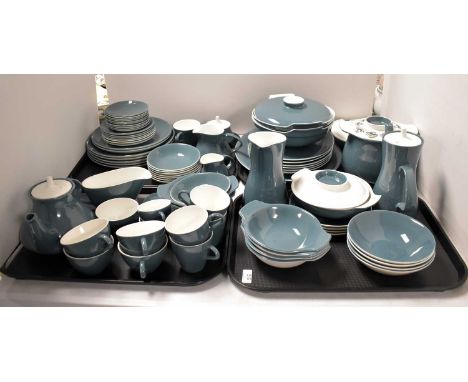 A Poole Pottery dinner service, including: a pair of tureens and covers; a smaller pair of tureens and covers; a tea pot; a c
