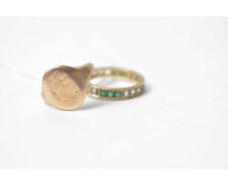 A 9ct yellow gold signet ring with engraved monograms; together with a green and white stone eternity ring, in 9ct gold mount