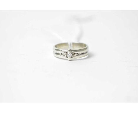 A diamond and 9ct white gold ring, the brilliant cut diamond flanked by scrolling decoration, ring size P, 4.5g gross. 