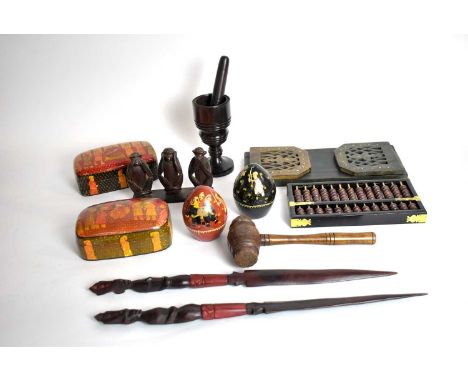A collection of Eastern and other treen collectible wares, including: a brass inlaid book slide; an ebonised and stained wood