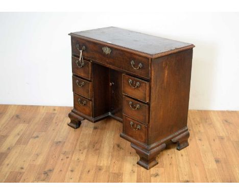 A mid 18th Century mahogany kneehole desk with secretaire drawer, the rectangular top with moulded edge, over the fall front 