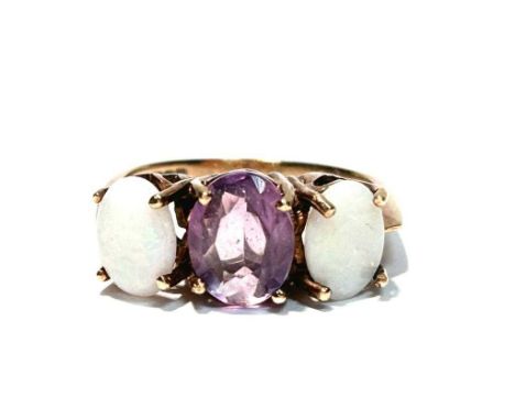 An opal and amethyst ring, the oval facet cut amethyst flanked by oval opal cabochons, 9ct yellow gold mount and shank, ring 