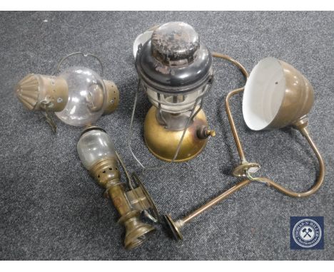 A wooden crate containing two early twentieth century brass light fittings, brass carriage lamp, oil lamp, tilly lamp