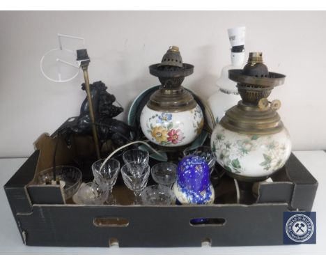 A box of converted oil lamps, spelter figural lamp, Russian dolls, assorted glass ware, signed framed print titled Practise r