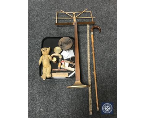 A tray of early twentieth century folding music stand, mohair teddy bear, folding ruler, vintage fishing reel together with a
