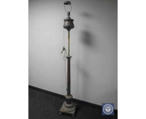 An antique brass rise and fall standard lamp