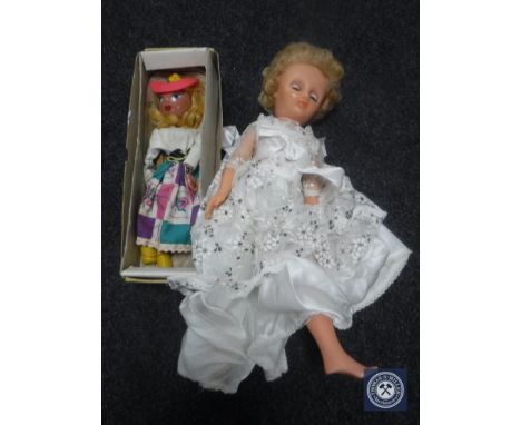 A box of mid 20th century doll in white dress and a boxed Pelham puppet 