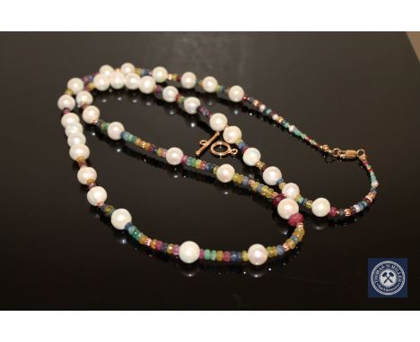 A cultured pearl, emerald, ruby and sapphire bead necklace, with gold clasp, length 84cm