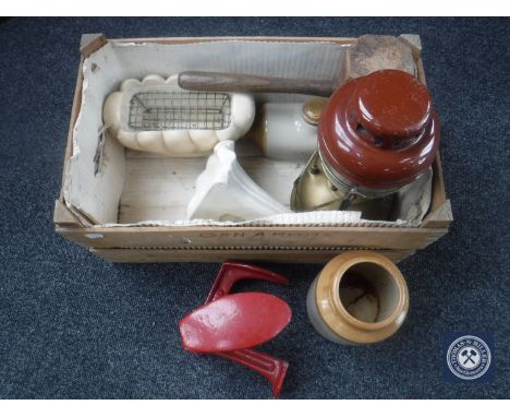 A wooden crate of tilly lamp, cobbler's last, stoneware bottles and hot water bottle 