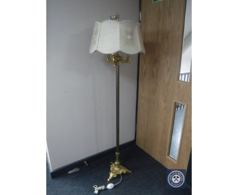 An ornate gilt standard lamp with shade 