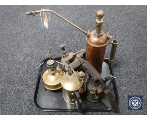 A tray of two antique copper and brass pump pots, oil lamp, brass stove etc