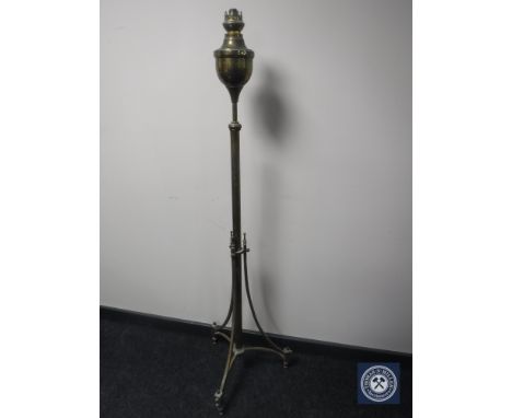 An antique brass rise and fall standard oil lamp 