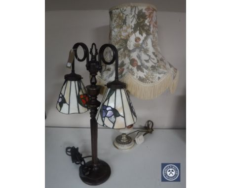 A metal table lamp with two Tiffany style shades together with a brass and marble table lamp with shade 