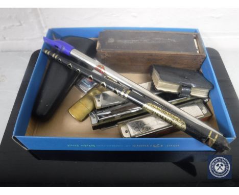 A box of tin whistles, harmonica, brass pocket lighter, cased dominoes, meerschaum cased pipe 