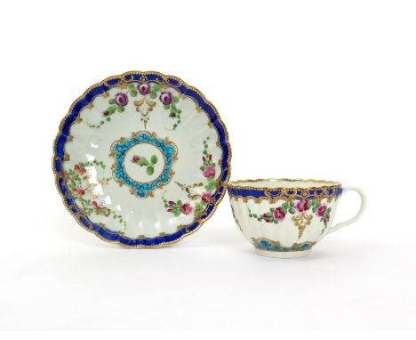 A Worcester teacup and saucer  c.1780-85, the fluted forms painted with the Royal Wedding pattern of three differing floral s