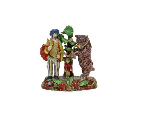 A Staffordshire group of a Savoyard and dancing bear c.1820-30, the travelling showman brightly attired in blue turban and ye