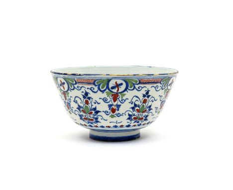 A large delftware bowl  c.1725, probably Bristol, the tall sides enamelled in red, green and blue with stylized flower sprays