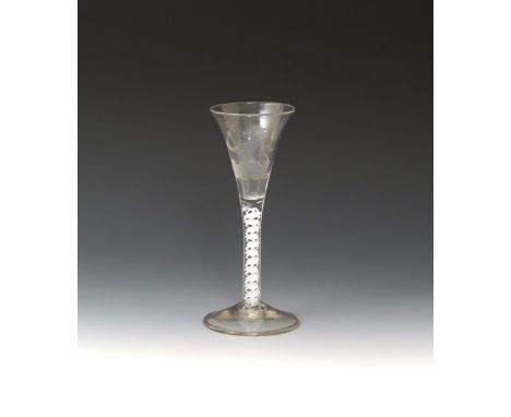 An armorial wine glass  c.1765, the drawn trumpet bowl probably engraved in the 19th century with the crest of a lion rampant