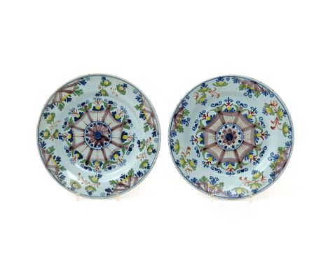 A pair of Lambeth delftware plates  late 18th century, of Ann Gomm type, decorated in polychrome enamels with a central octag