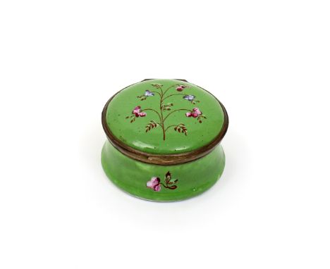 A Bilston enamel circular patch box  c.1780-90, simply decorated with a spray of raised enamel flowers on an apple green grou