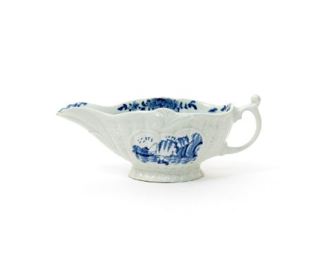 A Worcester blue and white strap-moulded sauceboat  c.1754, painted with the Moored Boat pattern, one side with a panel conta