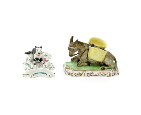 A Copeland and Garrett porcelain model of a donkey  c.1845, recumbent on a low base and fitted with yellow panniers to form m