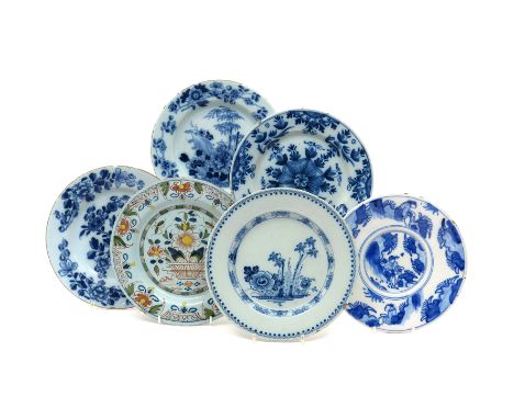Five English delftware plates  mid 18th century, three painted in blue with sprays of Oriental flowers including peony and ch