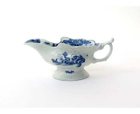 A Worcester blue and white moulded sauceboat  c.1755, painted with the Triangular Platform pattern, each side with a moulded 