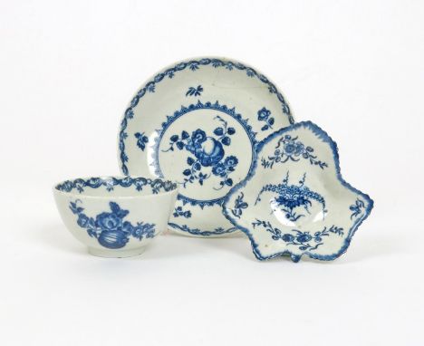 A Worcester blue and white teabowl and saucer  c.1770, printed with the Fruit and Wreath pattern, hatched crescent marks, and