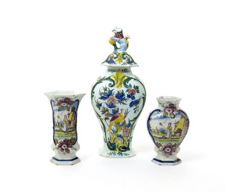 A large Delft vase and cover  19th century, brightly painted with a bird perched among flowering branches, the cover surmount