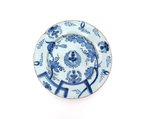 An English delftware plate  mid 18th century, painted in blue after the Chinese with a squirrel running along vine, with styl