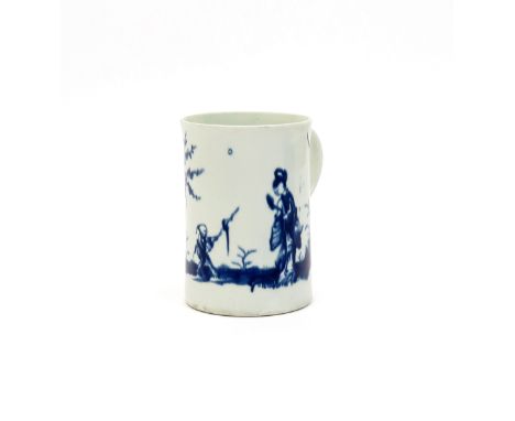 A large Worcester blue and white mug  c.1760, the tall cylindrical body applied with a grooved strap handle, painted with the