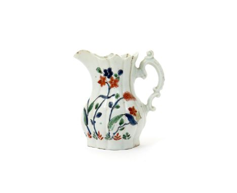 A rare and early Worcester cream jug  c.1752-53, of fluted baluster form with delicate and elaborately scrolled handle, paint