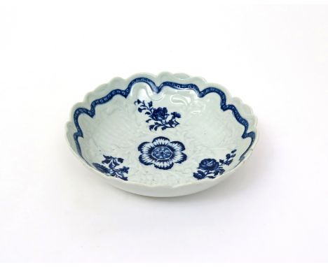 A Worcester blue and white junket dish  c.1762, crisply moulded with panels of basketweave around shaped cartouches, printed 