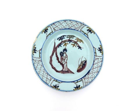 A Bristol delftware plate  c.1750, painted in manganese with highlights in green, yellow and blue, with a standing Chinese la