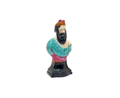 A pearlware bust of Neptune c.1800, modelled with a long black beard, wearing a fish scale robe, raised on a black socle base