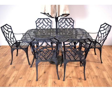 A contemporary garden table and six chairs, the pierced table of rectangular form, 155 x 96 x 73cm high, comes with umbrella 