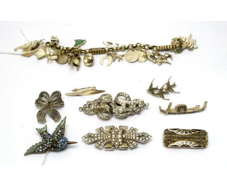 A charm bracelet mounted with silver and other charms; and a selection of silver and costume brooches, including a marcasite 