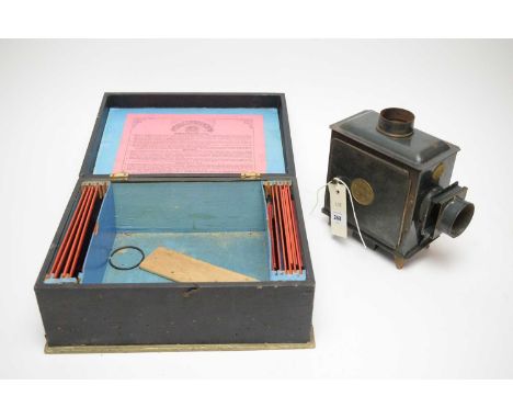 An Ernst Plank 'Standard E.P.' Magic Lantern, together with lantern slides, in original box, 30cms wide.