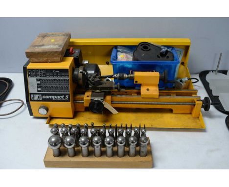 An Emco Compact 5 lathe, by Maier + Co, Austria, in yellow; with a selection of parts and accessories.
