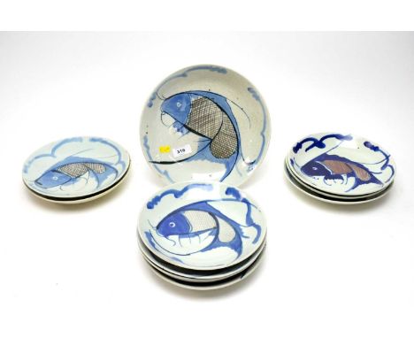 A collection of ceramic fish plates, each decorated with a blue fish on a grey background, the largest measuring 24.5cms in d