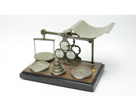 A set of Victorian postal scales, by Houghton &amp; Gunn, raised on a rectangular rosewood base, 41cms wide.