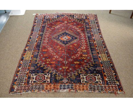 A vintage Hamedan Persian rug, the red ground with polychrome geometric panels, 300 x 149cm 
