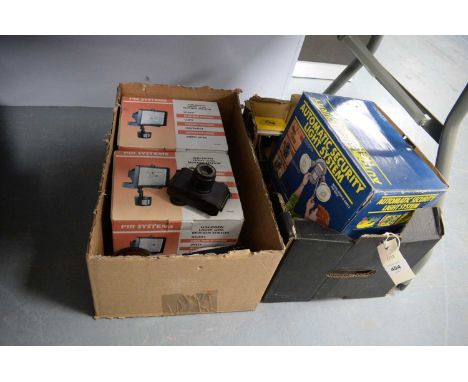 A UNI-COM Automatic Security Light System, in box; two PIR Systems halogen lights with motion sensors, each boxed; Orion Came