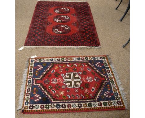A vintage 20th Century Afghan Aqsha rug, the red ground with gul medallions, 145 x 117cm, together with another rug, 