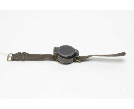 A military metal cased wrist-compass, the back stamped with broad arrow above 'Ref.No 6B/2595 Serial No.17403 B/63', with can